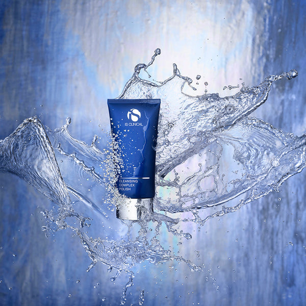 Blue skincare tube with water splashes on a blue background