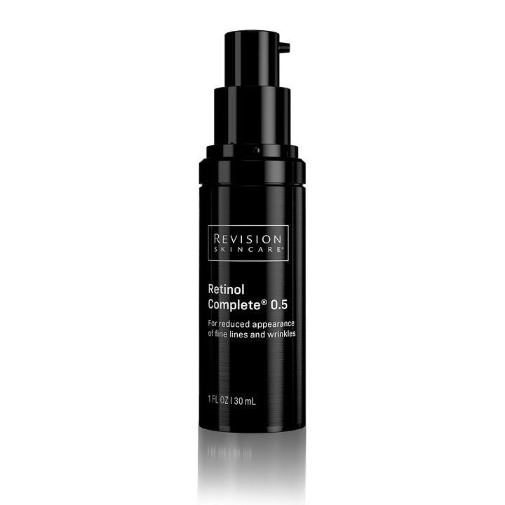 A black pump bottle of Revision Skincare Retinol Complete 0.5 on a clean white background with a subtle reflection below.