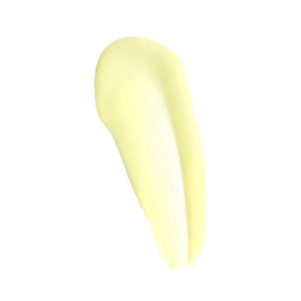 A thick, smooth smear of pale yellow cream or lotion on a solid white background.