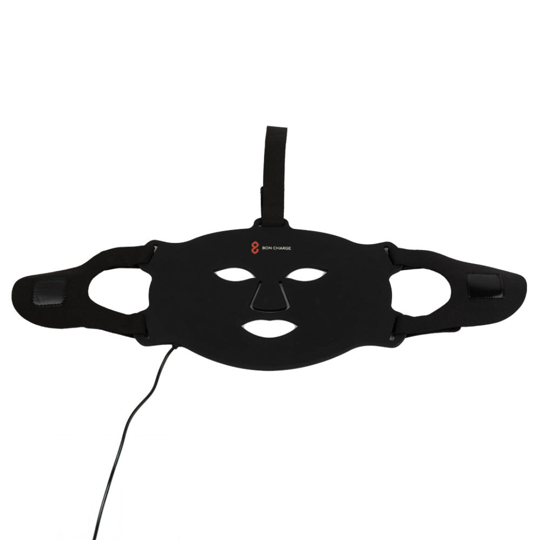 Black face mask with charging cable on a white background
