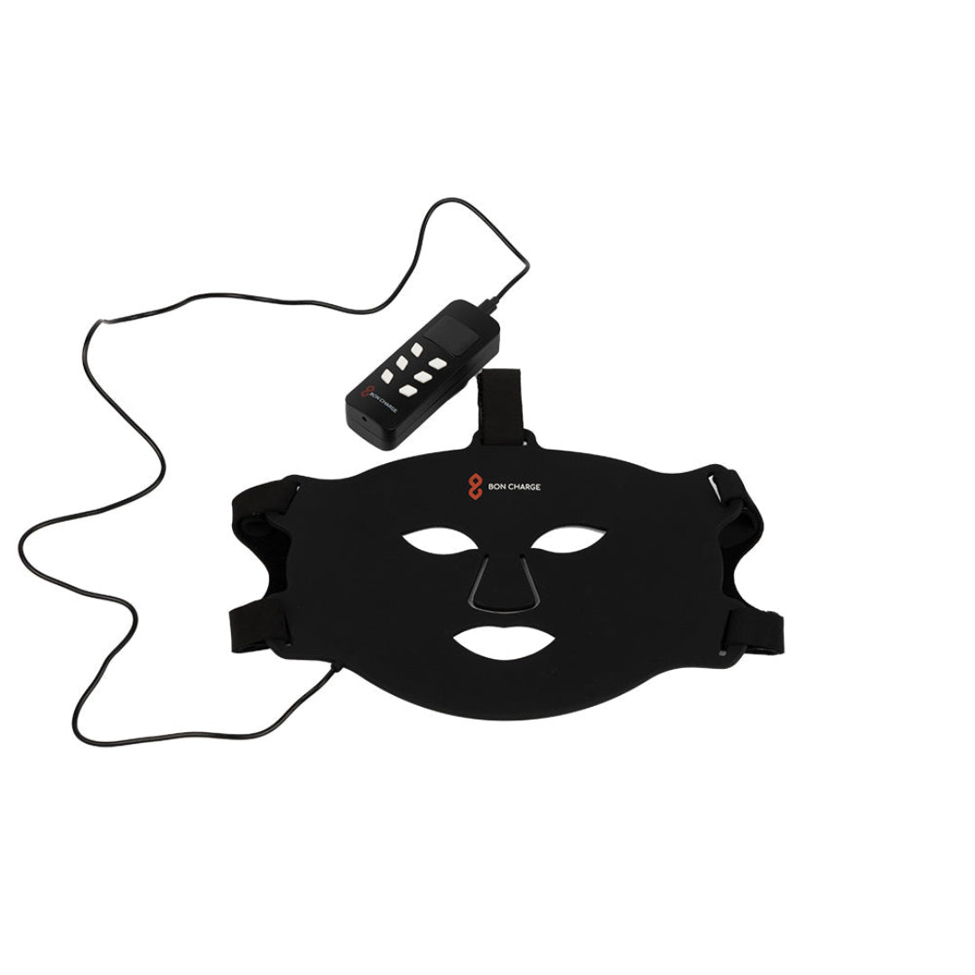 Black face mask with a control device on a white background