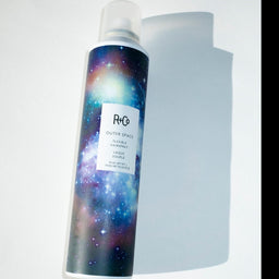 a cloup of a R+Co Outer Space Flexible Hairspray bottle