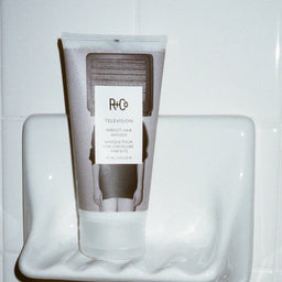 R+Co Television Perfect Hair Masque sat on a soap dish