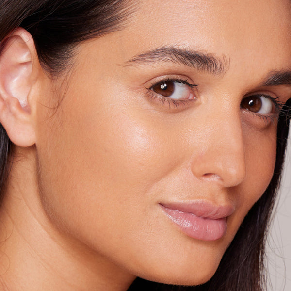 Close-up of a woman's face with a neutral background
