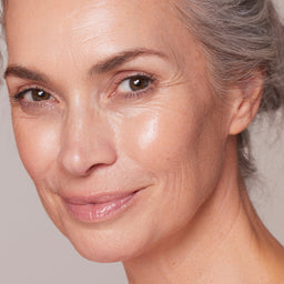 Close-up of a woman's face with a neutral background
