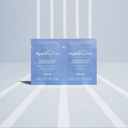 HydroPeptide skincare product packaging on a light blue and white striped background