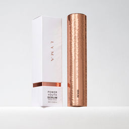 LYMA Power Youth Serum 30ml bottle in a hammered rose gold finish, standing next to its white and rose gold packaging box on a clean white surface.