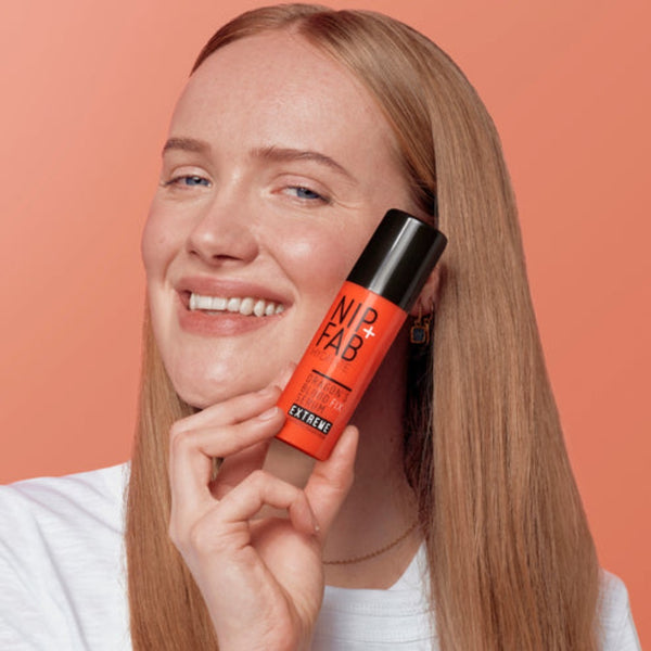 a model holding the serum bottle close to her face