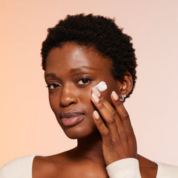 a model applying the moisturiser to her face
