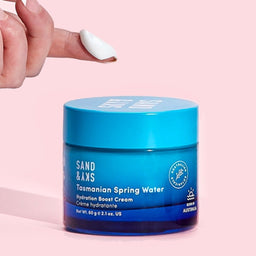 Model scooping out Sand & Sky Tasmanian Spring Water Hydration Boost Cream with their finger