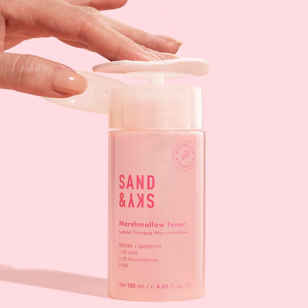 Model applying Sand & Sky Marshmallow Toner to a cotton pad
