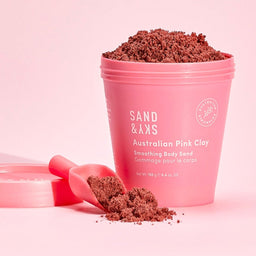 Sand & Sky Australian Pink Clay Smoothing Body Sand in the style of a sand bucket with a scoop of sand next to the bucket