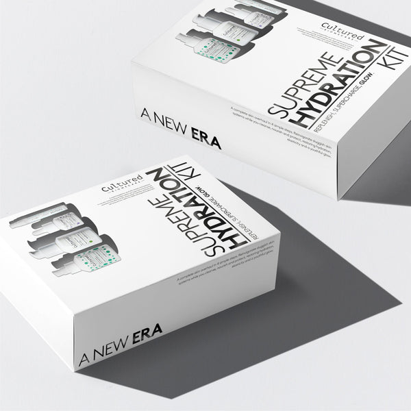 Two white product boxes for a 'Supreme Hydration Kit' by 'Gluired' and 'A New Era' arranged diagonally on a light gray background with soft shadows.