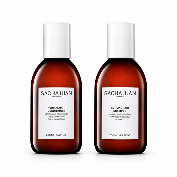 Two Sachajuan Stylisten normal hair care bottles on a white background, featuring an amber brown bottle design with white caps and white labels.
