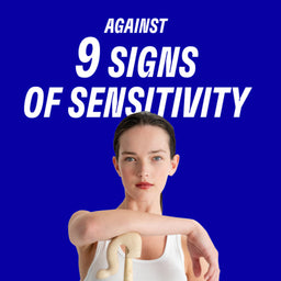 Woman holding a wooden object against a blue background with text about sensitivity signs.