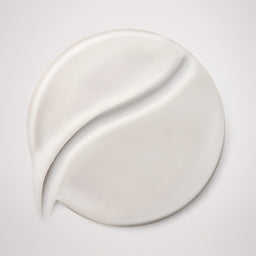 White cream smear on a light gray background