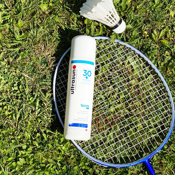 White Ultrasun Sports Gel SPF 30 200ml on badminton racket