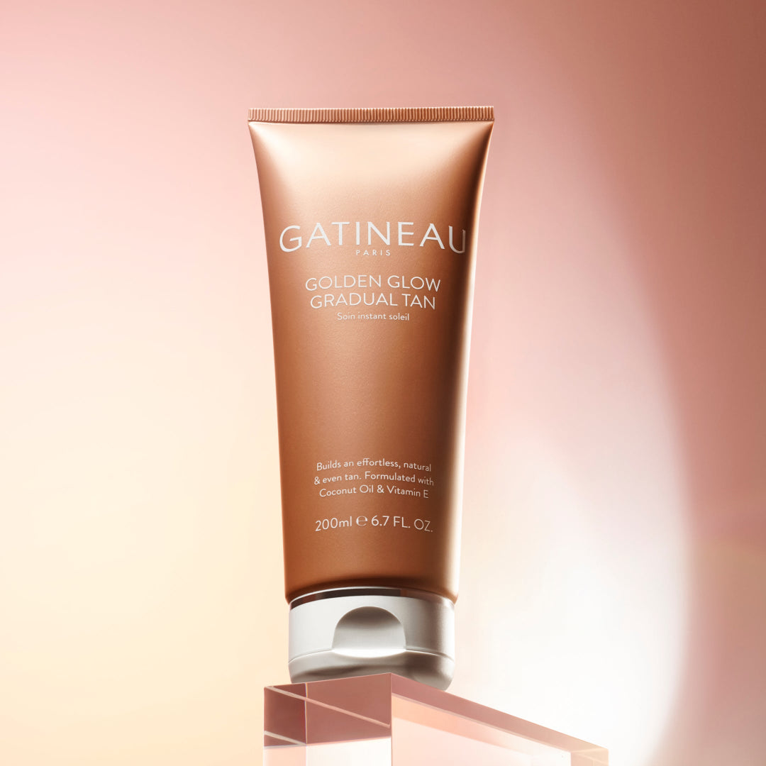 Gatineau Golden Glow Gradual Tan tube on a gradient pink background