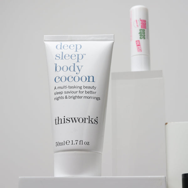Two skincare products on a gray background, one labeled 'deep sleep body cocoon' and the other 'this works'.