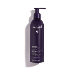 A single bottle of Caudalie Densy & Volume Shampoo in a dark purple pump bottle, photographed on a clean white background with a soft shadow.