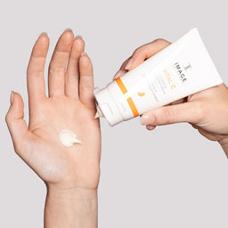 A model applying the serum to the palm of their hand