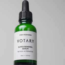 Votary super renewal serum bottle on a gray background