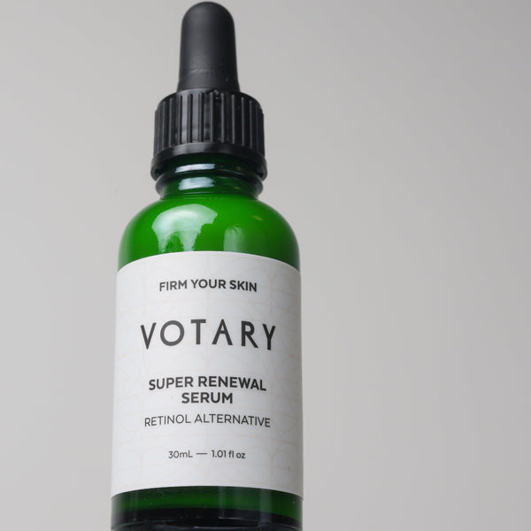 Votary super renewal serum bottle on a gray background