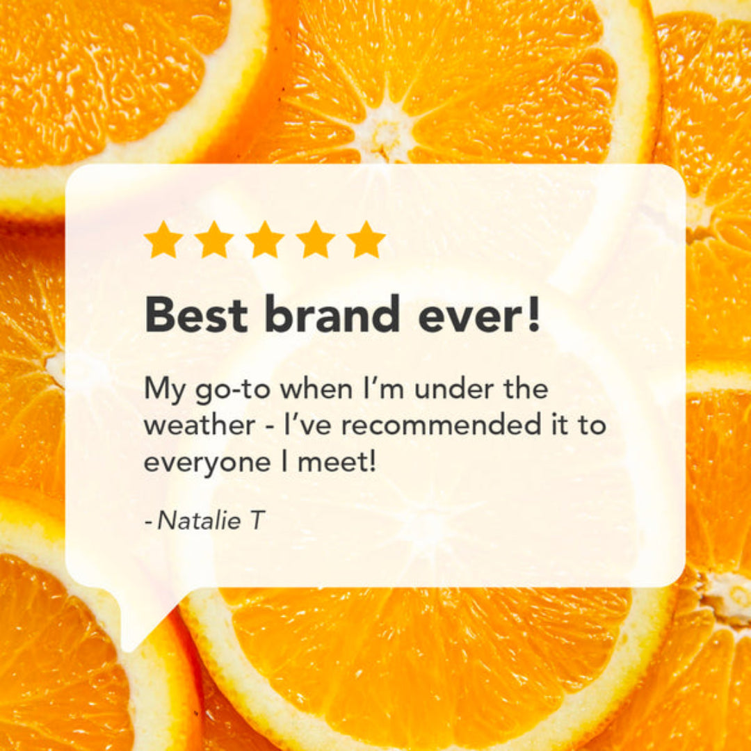 A promotional graphic with a white rounded speech-bubble style card over a background of sliced orange fruit. The card contains a five-star rating and a quote: 'Best brand ever! My go-to when I'm under the weather - I've recommended it to everyone I meet! -Natalie T'.