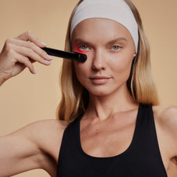 Woman Using Red Light Face Wand