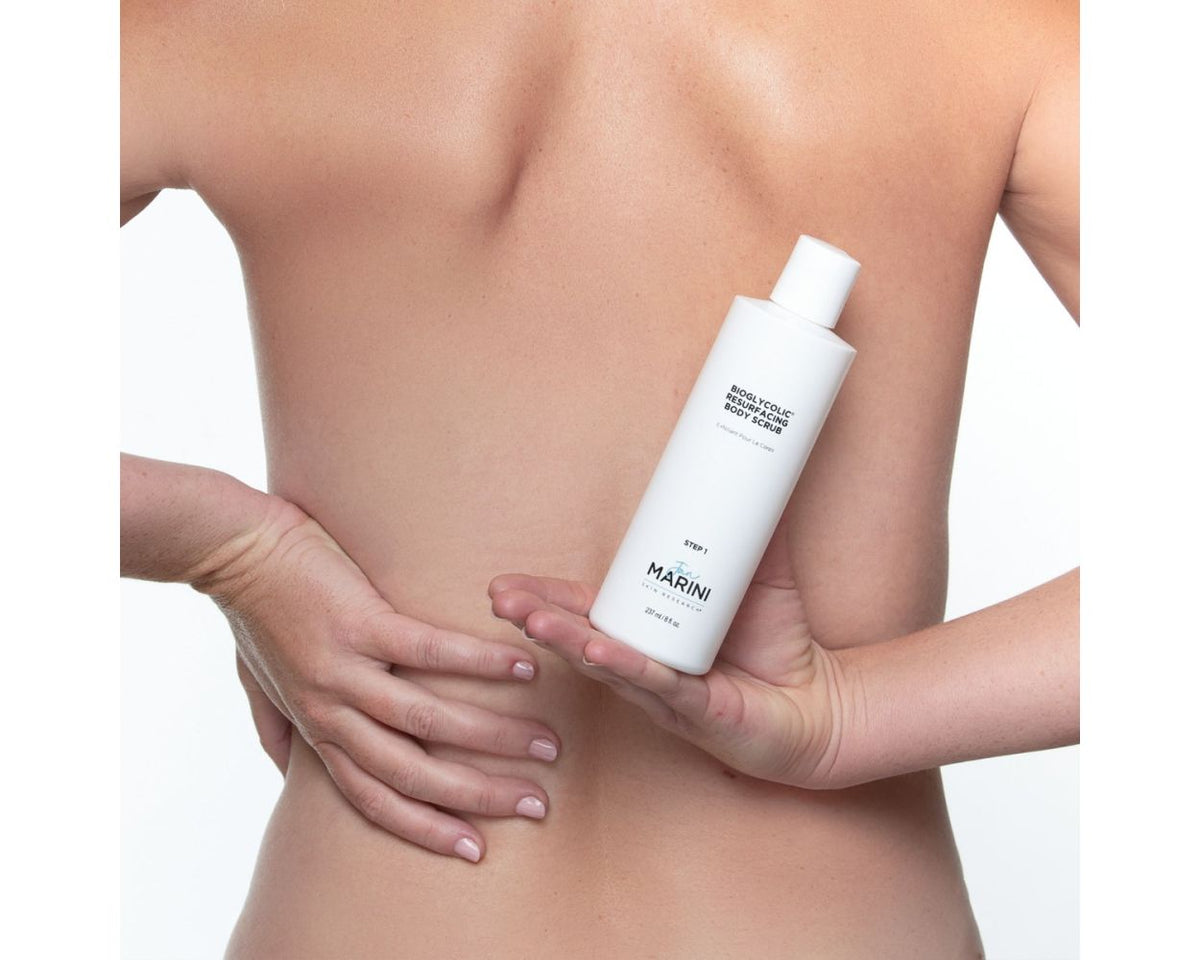 a model holding the scrub bottle to their back