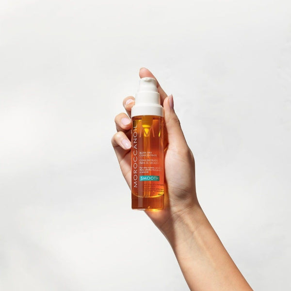 Moroccanoil Blow Dry Concentrate bottle being held to the air