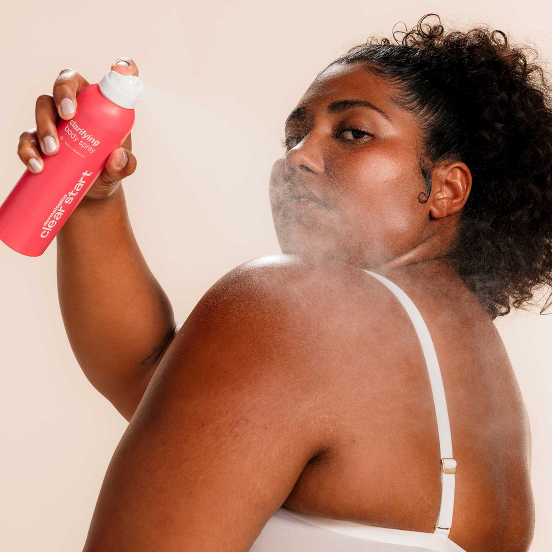 Model applying Dermalogica Clarifying Body Spray