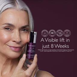 A close-up of a smiling woman with silver-gray hair holding a bottle of Gatineau DerLift+ facial moisturizing serum against a dark plum background, with text and certification icons on the right.