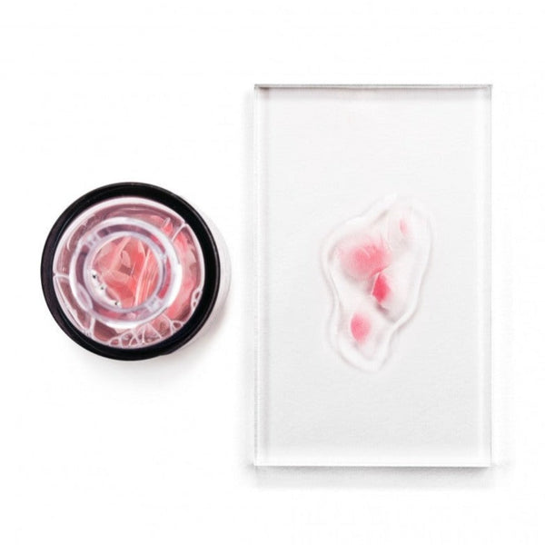Avant Skincare Damascan Rose Petals Revitalising Facial Serum poured onto a slate