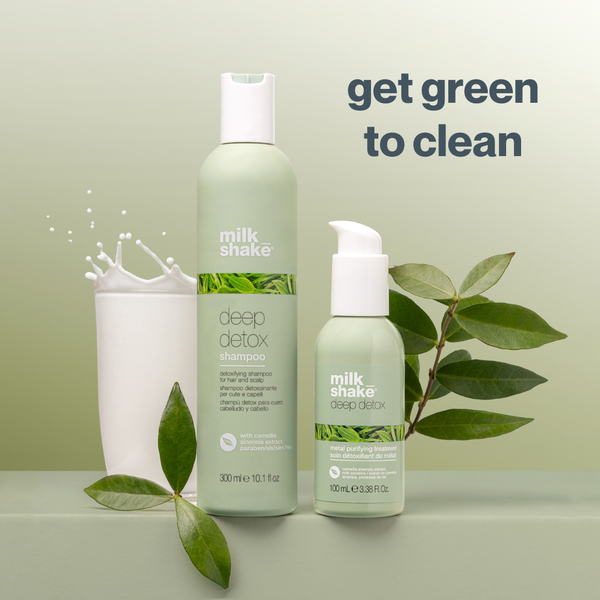 Two bottles of milk_shake deep detox shampoo and conditioner on a light green background with leaves.