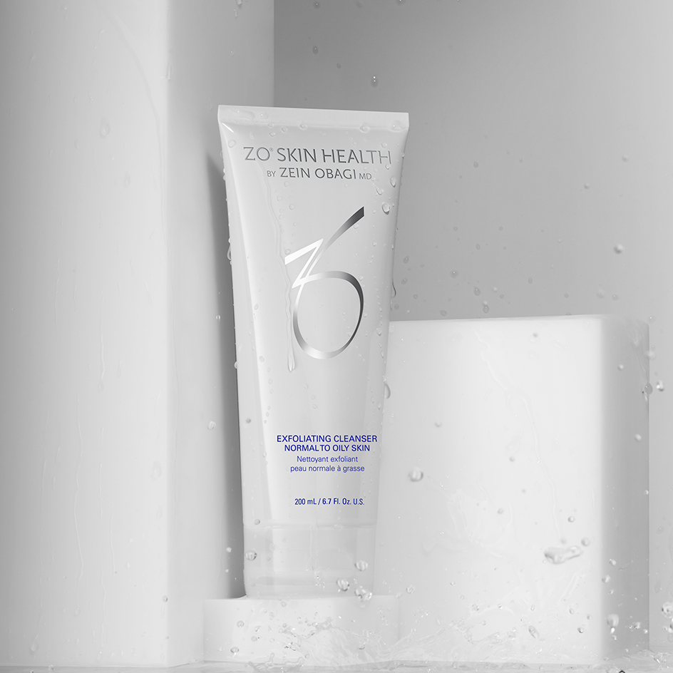 White ZO Skin Health Exfoliating Cleanser tube with water splashes