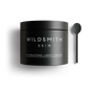 Black jar of Wildsmith Skin hydrating light cream with a spoon on a white background