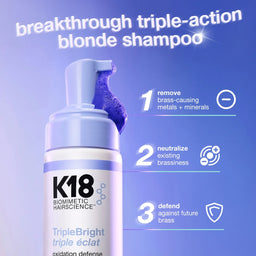 K18 shampoo bottle with blue pump on a purple background