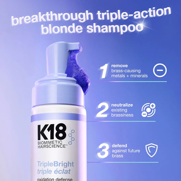 K18 shampoo bottle with blue pump on a purple background