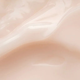 A close-up of a glossy, smooth beige surface with soft wavy highlights and shadows, resembling a pale peach-beige material swatch.