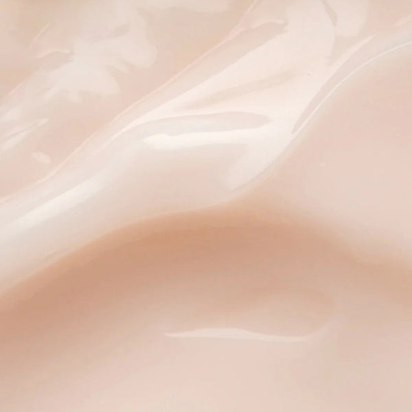 A close-up of a glossy, smooth beige surface with soft wavy highlights and shadows, resembling a pale peach-beige material swatch.