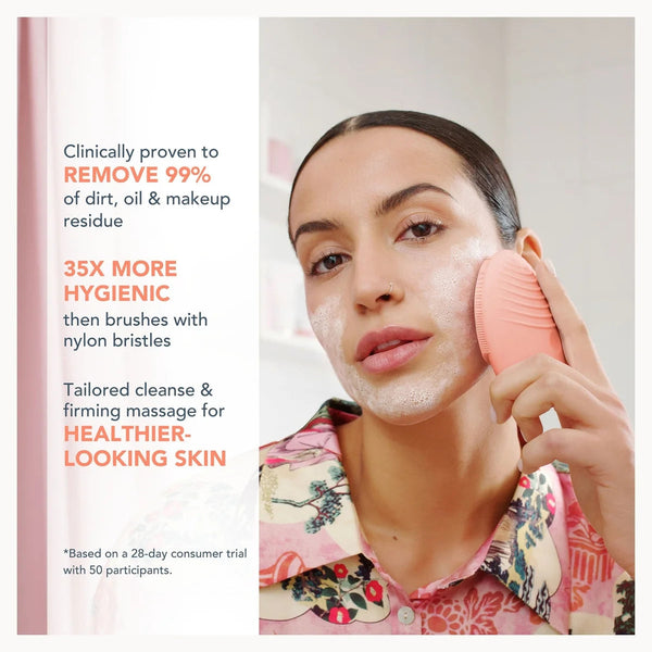 A woman with white cleanser foam on her face holds a pink silicone cleansing brush against her cheek. The left side features promotional text highlighting the product's clinical efficacy, 99% dirt, oil, and makeup residue removal, and 35x more hygiene than standard brushes.