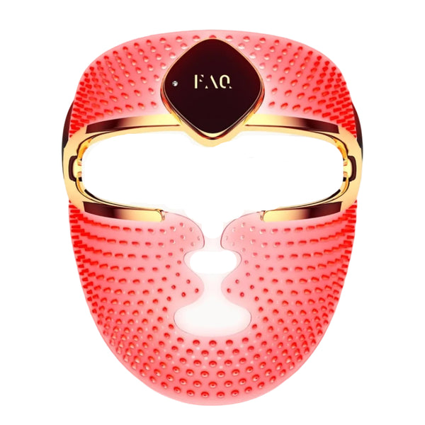 A red silicone facial massage mask with gold trim and a central dark brown plaque featuring the gold 'FAQ' logo, shown on a solid white background.
