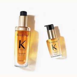 Two bottles of Kerastase hair product on a white background
