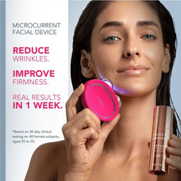 A woman holds a bright pink circular microcurrent facial device against her cheek, with text on the left reading 'MICROCURRENT FACIAL DEVICE' and claims about reducing wrinkles and improving firmness. She also holds a rose-gold cosmetic tube.