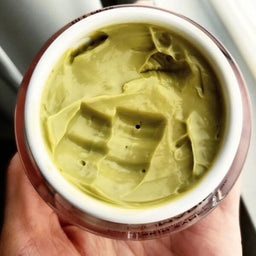 An open jar of Jan Marini Skin Zyme Papaya Mask showing its green mask contents
