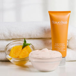 Natura Bisse C+C Vitamin Souffle Mask next to a towel and chunks of fruiy