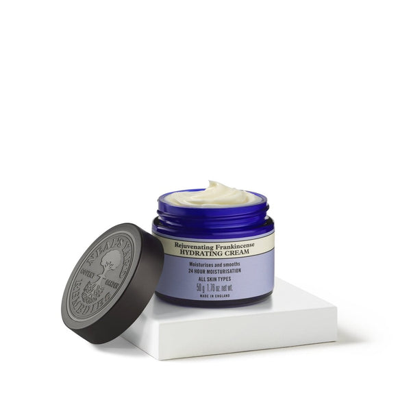 Neal's Yard Remedies Frankincense Hydrating Cream with no lid on a white pedestal 