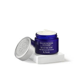 Neal's Yard Remedies Frankincense Intense Age Defying Cream tub with no lid on a white pedestal 