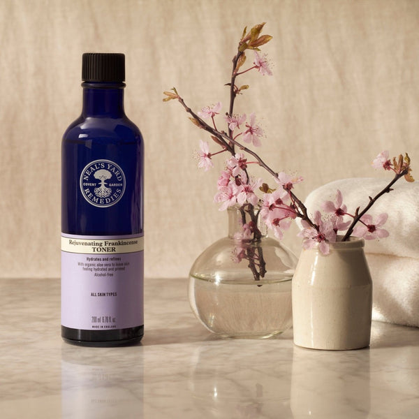 Neal's Yard Remedies Rejuvenating Frankincense Toner next to a brand of small flowers